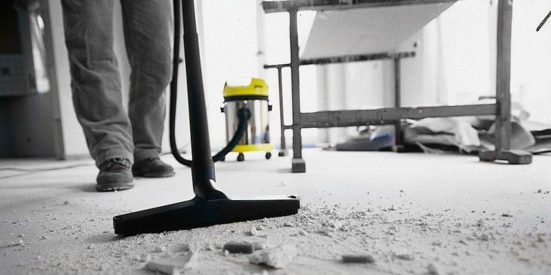 Vacuuming dust from the floor after completing works